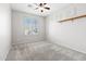 This bedroom features carpeted flooring, a built-in shelf, and a ceiling fan at 8872 W Hollywood Ave, Peoria, AZ 85345