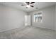 This bedroom features neutral walls, a ceiling fan, and window with plantation shutters at 8872 W Hollywood Ave, Peoria, AZ 85345