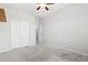 Bright bedroom showcasing sliding closet doors and neutral carpeting at 8872 W Hollywood Ave, Peoria, AZ 85345
