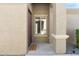 Covered entryway with a dark wood door, 'Welcome' mat, and sidelight window for natural light at 8872 W Hollywood Ave, Peoria, AZ 85345
