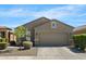 Charming single-story home with a two-car garage, landscaped front yard, and neutral color palette at 8872 W Hollywood Ave, Peoria, AZ 85345