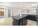 Granite kitchen island with pendant lighting, stainless steel refrigerator, and slider door to outdoor area at 8872 W Hollywood Ave, Peoria, AZ 85345
