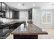 Kitchen featuring dark cabinets, granite countertops, stainless steel appliances, and a tiled floor at 8872 W Hollywood Ave, Peoria, AZ 85345