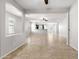 Spacious open-concept living room with tile floors, neutral paint, and sightlines to the kitchen at 8872 W Hollywood Ave, Peoria, AZ 85345