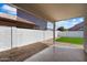 Covered patio with low maintenance landscape and white block wall at 9143 W Kings Ave, Peoria, AZ 85382