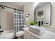 Well-lit bathroom with a sleek vanity, decorative mirror, and shower over the tub at 9143 W Kings Ave, Peoria, AZ 85382