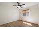 A bright bedroom featuring a ceiling fan, window with blinds, and neutral-toned walls at 9143 W Kings Ave, Peoria, AZ 85382