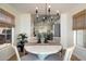 Cozy dining area with round table, stylish chandelier, and inviting natural light at 9143 W Kings Ave, Peoria, AZ 85382