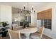 Charming dining area showcases a round table, modern chandelier, and views into the kitchen at 9143 W Kings Ave, Peoria, AZ 85382