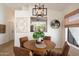 Elegant dining area with contemporary lighting and an open view into the kitchen at 9143 W Kings Ave, Peoria, AZ 85382