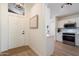 Welcoming entryway leading to a modern kitchen featuring white cabinetry and stainless steel appliances at 9143 W Kings Ave, Peoria, AZ 85382