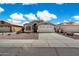Inviting single-story home featuring a two car garage and a well maintained front yard at 9143 W Kings Ave, Peoria, AZ 85382