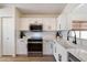 Modern kitchen features white cabinets, quartz countertops, stainless steel appliances, and subway tile backsplash at 9143 W Kings Ave, Peoria, AZ 85382