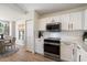 Modern kitchen features white cabinets, quartz countertops, stainless steel appliances, and subway tile backsplash at 9143 W Kings Ave, Peoria, AZ 85382