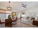 Open-concept living area with dining table, comfortable seating, and a sliding glass door at 9143 W Kings Ave, Peoria, AZ 85382