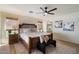 Comfortable main bedroom with a wooden bed frame, ceiling fan, and neutral decor at 9143 W Kings Ave, Peoria, AZ 85382