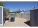 Spacious backyard with gravel landscape, block wall, shed, and AC unit at 9733 E Baywood Ave, Mesa, AZ 85208