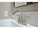 Close up of the sink faucet in a bathroom, featuring modern fixtures and white countertops at 9733 E Baywood Ave, Mesa, AZ 85208