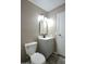 Neutral bathroom with white toilet, gray vanity, and sleek black hardware at 9733 E Baywood Ave, Mesa, AZ 85208