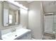 Bathroom vanity with modern lighting and fixtures, complemented by a glass-enclosed shower at 9733 E Baywood Ave, Mesa, AZ 85208