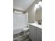 Bathroom with a modern sink and vanity, complemented by a shower-tub and tile surround at 9733 E Baywood Ave, Mesa, AZ 85208
