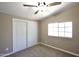 Cozy bedroom with natural lighting, neutral colors and a closet at 9733 E Baywood Ave, Mesa, AZ 85208