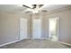 Spacious bedroom featuring a ceiling fan and two doors, and is painted in neutral colors at 9733 E Baywood Ave, Mesa, AZ 85208