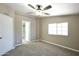 Bedroom with a ceiling fan and ensuite bathroom access, with carpet flooring and a window at 9733 E Baywood Ave, Mesa, AZ 85208