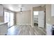 Bright dining area adjacent to kitchen featuring stylish lighting, vinyl floors, and pantry at 9733 E Baywood Ave, Mesa, AZ 85208