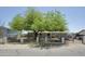 Home with shade tree in front of house and black metal fence around the property at 9733 E Baywood Ave, Mesa, AZ 85208