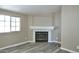 Close up of a living room fireplace with neutral walls and new laminate flooring at 9733 E Baywood Ave, Mesa, AZ 85208