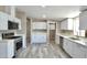 Bright kitchen featuring white cabinets, stainless steel appliances, and modern countertops at 9733 E Baywood Ave, Mesa, AZ 85208