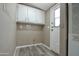 A neutral laundry area equipped with white cabinets and a washer/dryer hook-up at 9733 E Baywood Ave, Mesa, AZ 85208