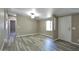 Living room featuring a fireplace, neutral walls, laminate flooring and natural light at 9733 E Baywood Ave, Mesa, AZ 85208