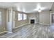 Spacious living room with a fireplace, neutral paint, and laminate wood flooring at 9733 E Baywood Ave, Mesa, AZ 85208