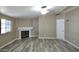 A living room featuring a fireplace, neutral walls, new flooring and a ceiling fan at 9733 E Baywood Ave, Mesa, AZ 85208