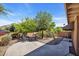 Private backyard patio featuring mature trees, desert landscaping, and a cozy seating arrangement at 1023 E Sahuaro Dr, Phoenix, AZ 85020