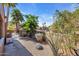 Side yard with gravel landscaping, block wall, and mature trees and plants at 1023 E Sahuaro Dr, Phoenix, AZ 85020
