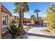 Serene backyard with desert landscaping, mature palm trees, and a cozy seating area at 1023 E Sahuaro Dr, Phoenix, AZ 85020