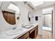Bathroom featuring double sinks and mirrors with a tiled countertop at 1023 E Sahuaro Dr, Phoenix, AZ 85020