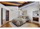 Bright bedroom with vaulted wood ceiling and bathroom access at 1023 E Sahuaro Dr, Phoenix, AZ 85020