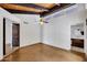 Bright bedroom with vaulted ceiling, fan, and bathroom access at 1023 E Sahuaro Dr, Phoenix, AZ 85020