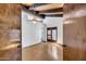 Spacious bedroom with ceiling beams, fan, and double-door access at 1023 E Sahuaro Dr, Phoenix, AZ 85020