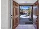Charming entryway with open double doors, revealing a desert landscape and an inviting pathway at 1023 E Sahuaro Dr, Phoenix, AZ 85020