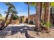 Exterior of home with desert landscaping features lush palm trees and a gated entryway at 1023 E Sahuaro Dr, Phoenix, AZ 85020
