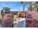Inviting single-story home entrance with desert landscaping, gated courtyard and a private walkway at 1023 E Sahuaro Dr, Phoenix, AZ 85020