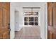 Bright, tiled living room with high ceilings, modern fan, and views of an enclosed patio at 1023 E Sahuaro Dr, Phoenix, AZ 85020