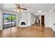 Bright living room with fireplace and sliding door access to the exterior at 1023 E Sahuaro Dr, Phoenix, AZ 85020