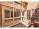 Enclosed patio with a view of the interior, a tan door, and a stone floor at 1023 E Sahuaro Dr, Phoenix, AZ 85020