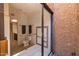 Walk-in shower with clear glass door provides ample space, while decorative tile and seat add comfort at 1023 E Sahuaro Dr, Phoenix, AZ 85020
